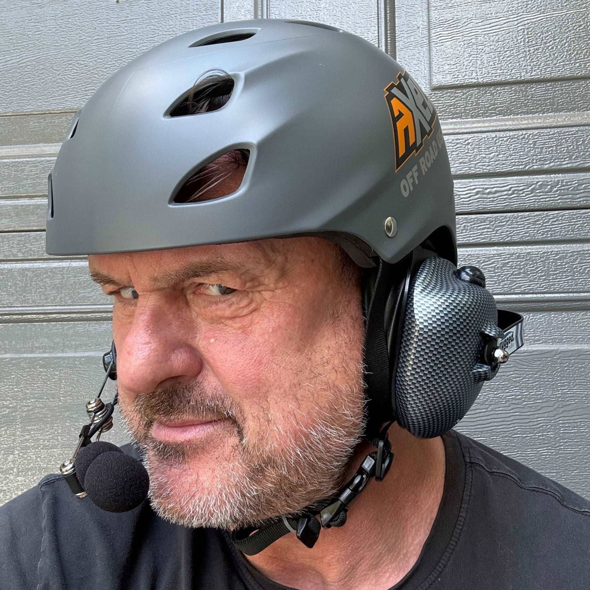 Person wearing the AXEL Off Road trail helmet with a headset accessory