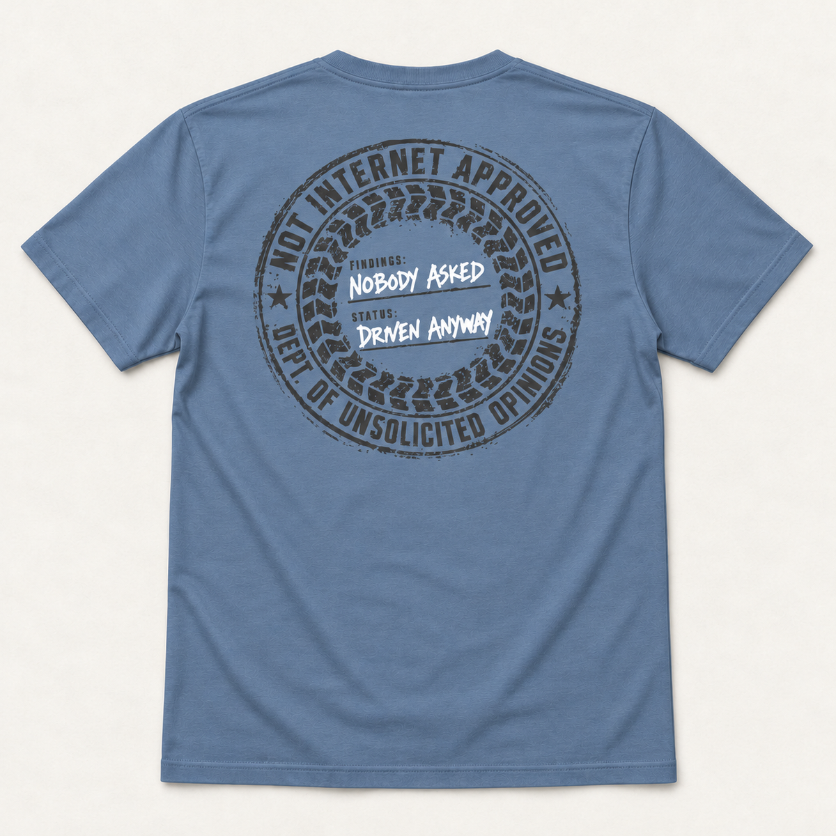 Nobody Asked tee in Slate blue, back flat lay showing the Not Internet Approved tire stamp with Nobody Asked and Driven Anyway.
