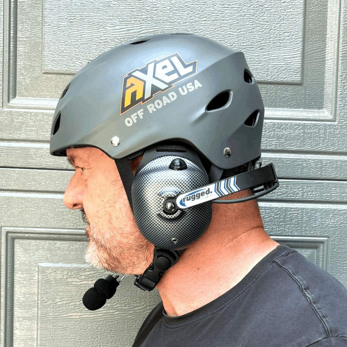 Person wearing the AXEL Off Road trail helmet with a headset accessory