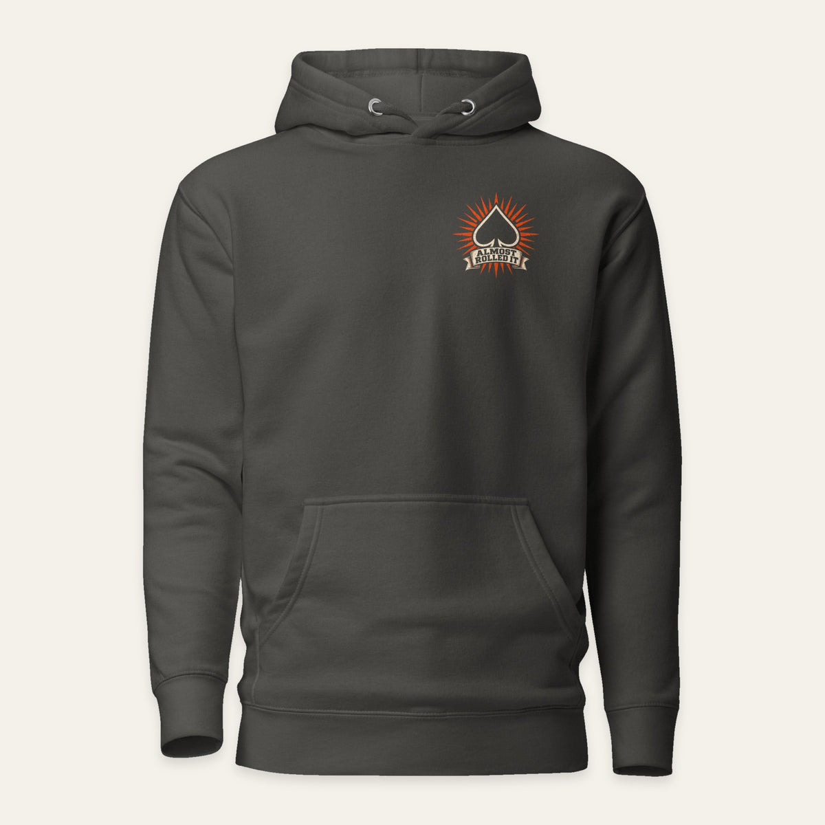 ARI Pullover Hoodie in Vintage Black — front flat lay. Supplier-derived product mockup; chest artwork and placement preserved.