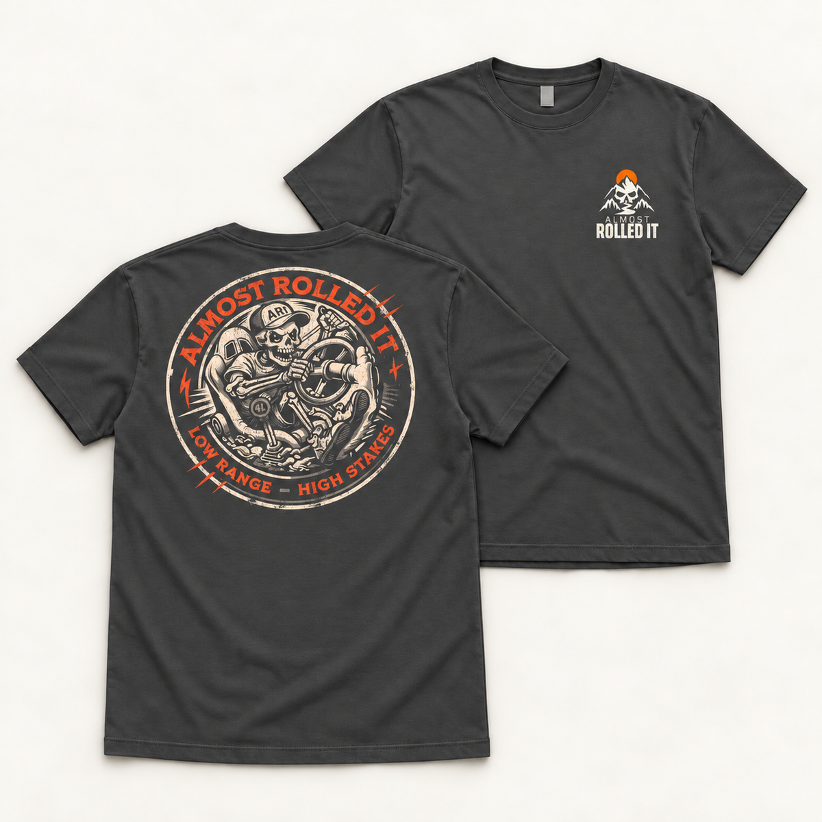 Front and back flat lays of the Dark Grey 4Lo Skull tee with small orange-sun chest mark and round skeleton-driver back print.