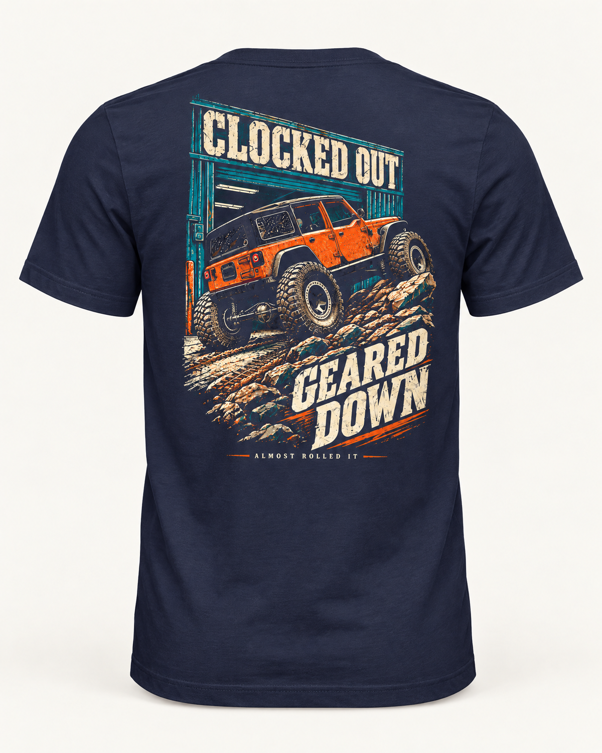 Clocked Out tee in navy, back view: cream CLOCKED OUT lettering over a teal garage door, an orange rig rolling out onto rocks, GEARED DOWN below
