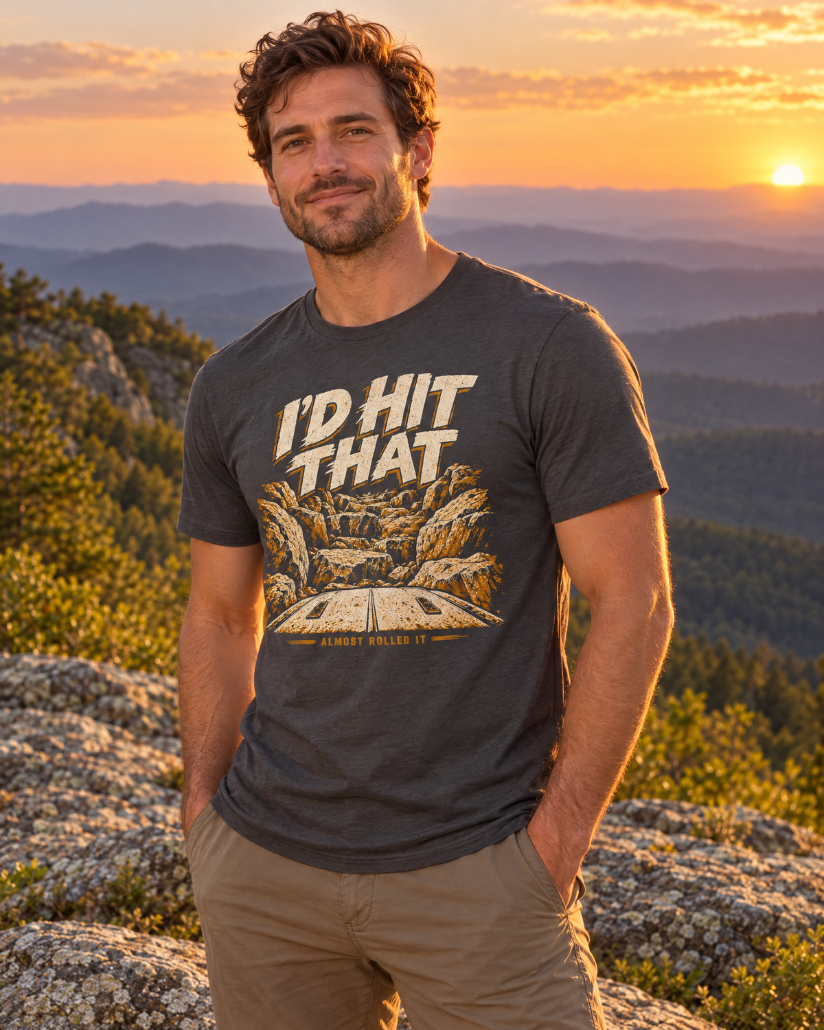 Man on a Blue Ridge ledge at sunset wearing the dark grey I'd Hit That tee, front print visible