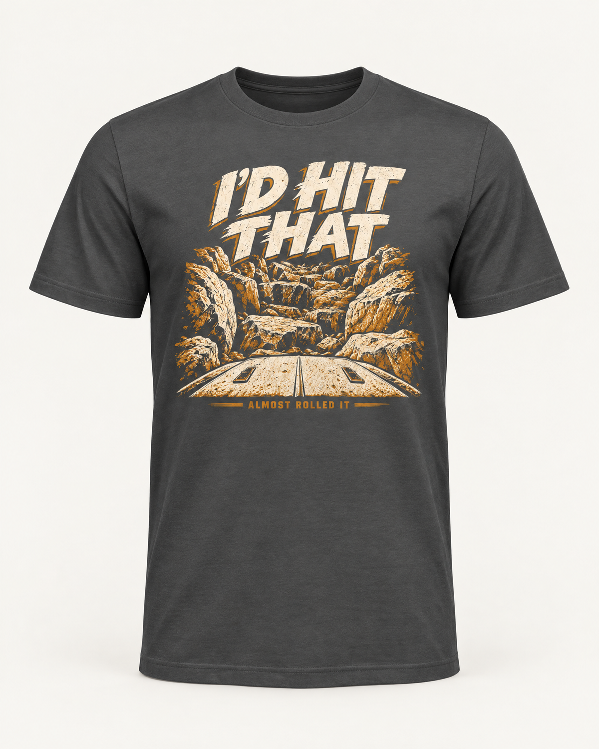 I'd Hit That tee in dark grey, front view: cream I'D HIT THAT lettering over a boulder canyon illustration, ALMOST ROLLED IT below