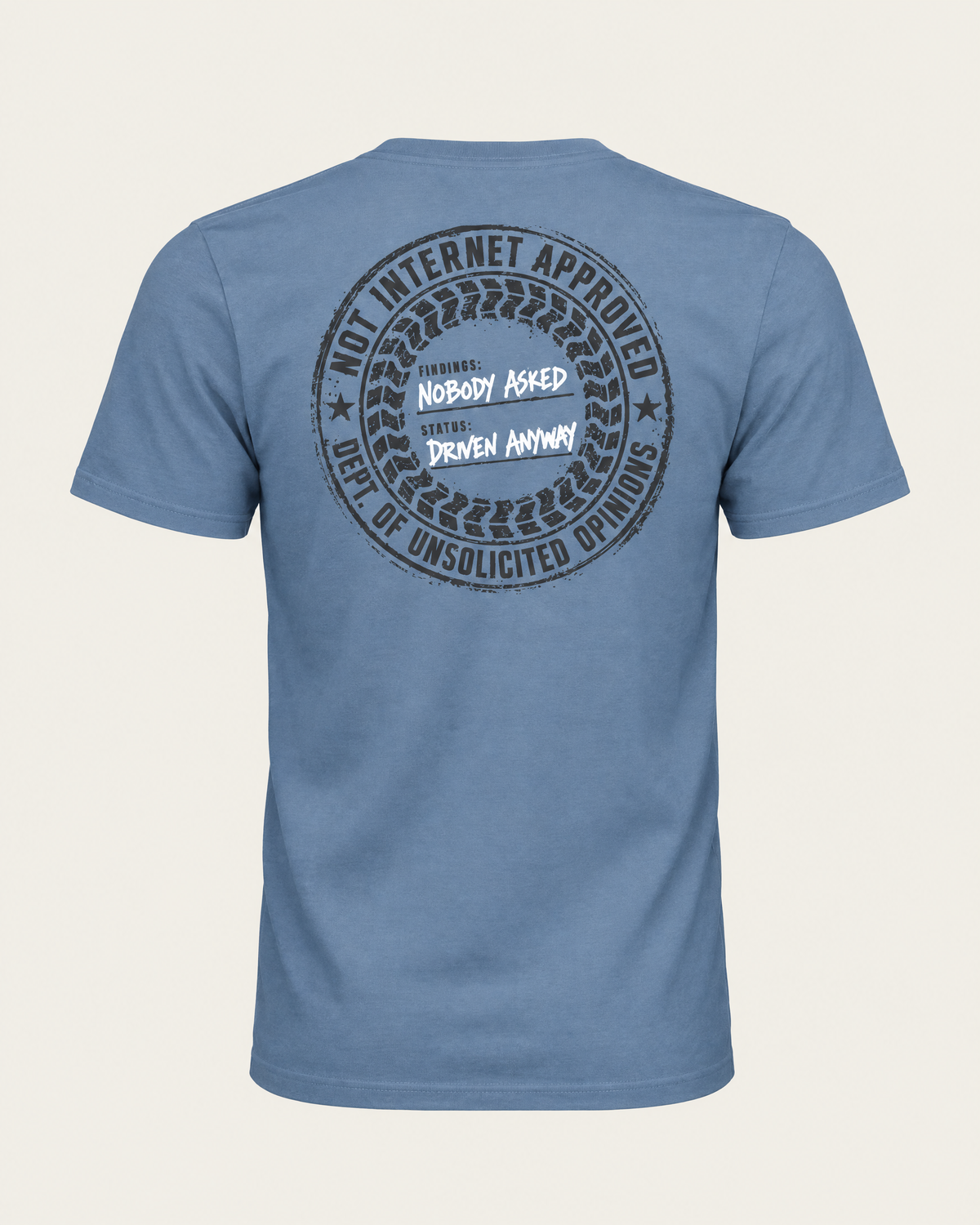 Nobody Asked tee in slate blue, back view: round charcoal stamp reading Not Internet Approved, Dept. of Unsolicited Opinions, Findings: Nobody Asked, Status: Driven Anyway