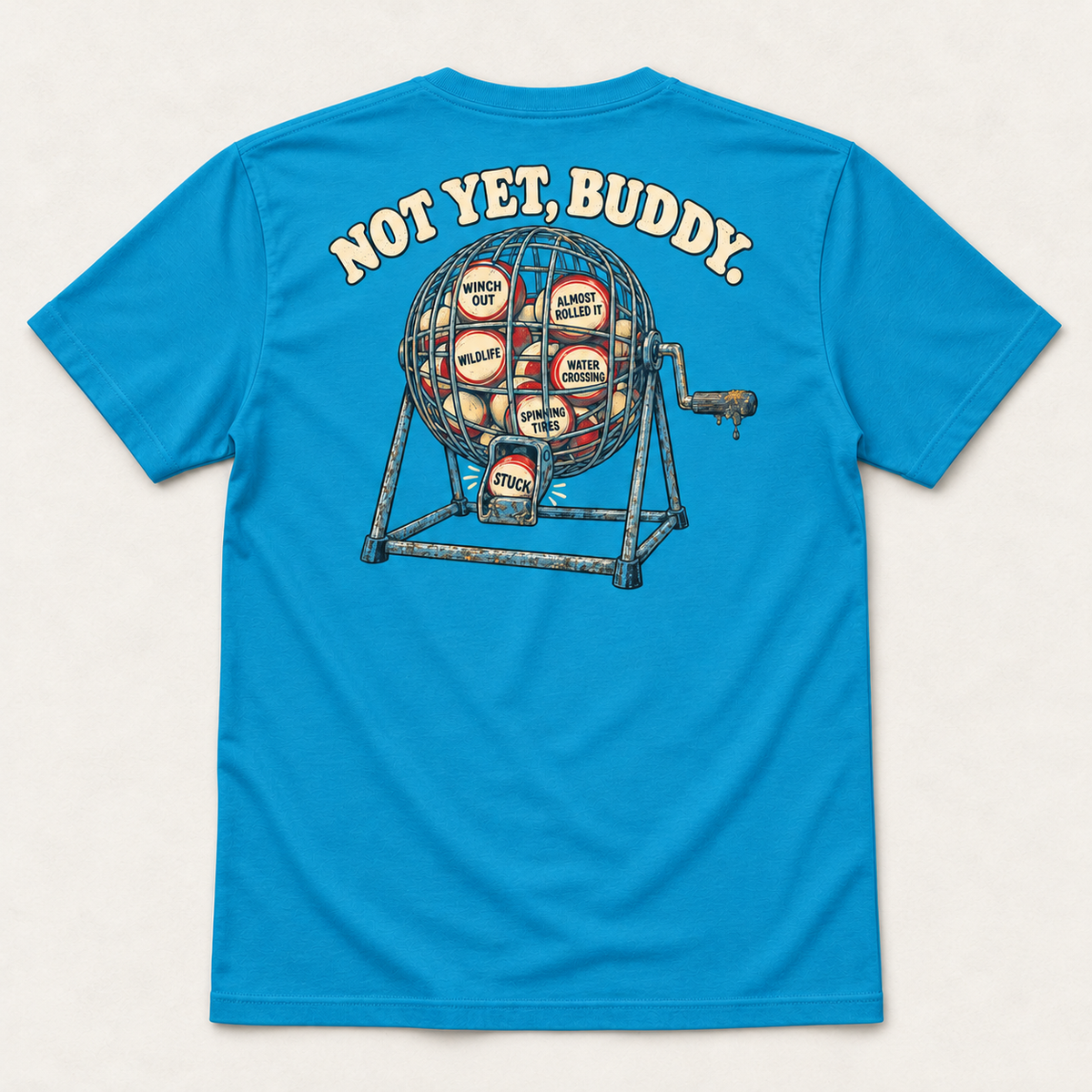 Are We Stuck Yet? adult tee in Electric Blue, complete back flat lay showing the Not Yet, Buddy bingo-cage print.
