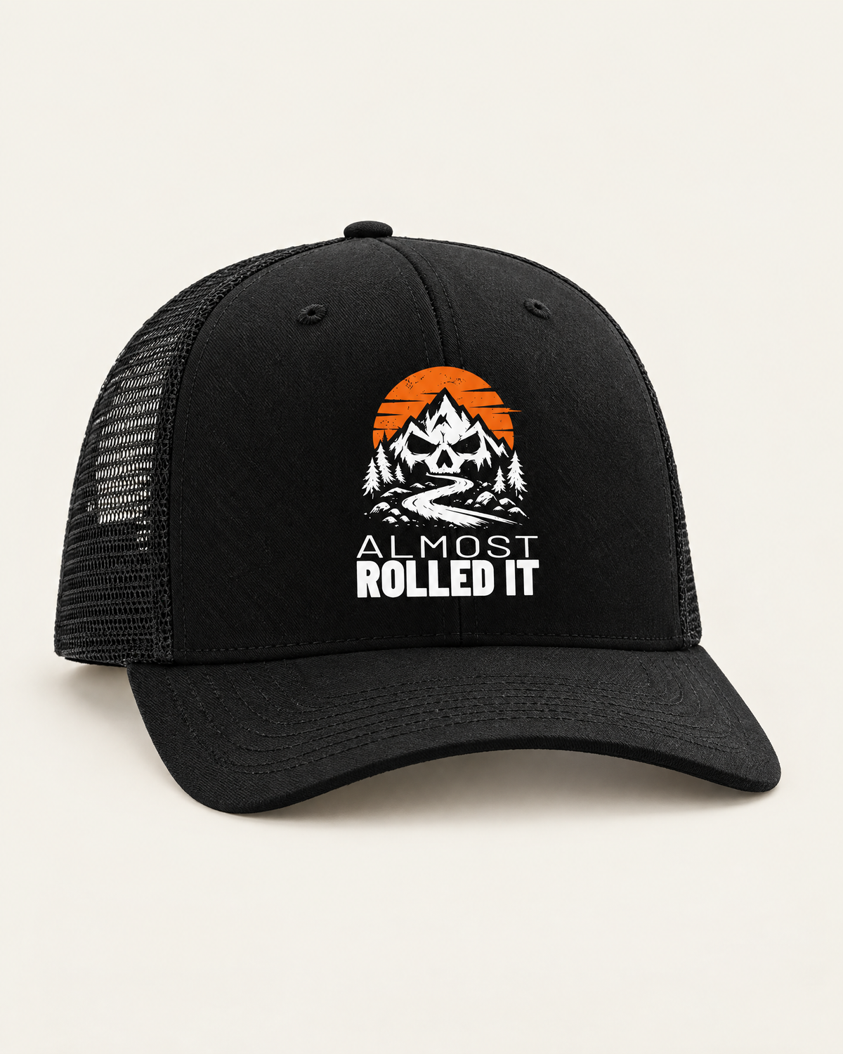 Almost Rolled It trucker hat in black: skull-and-mountains logo on the front, mesh back