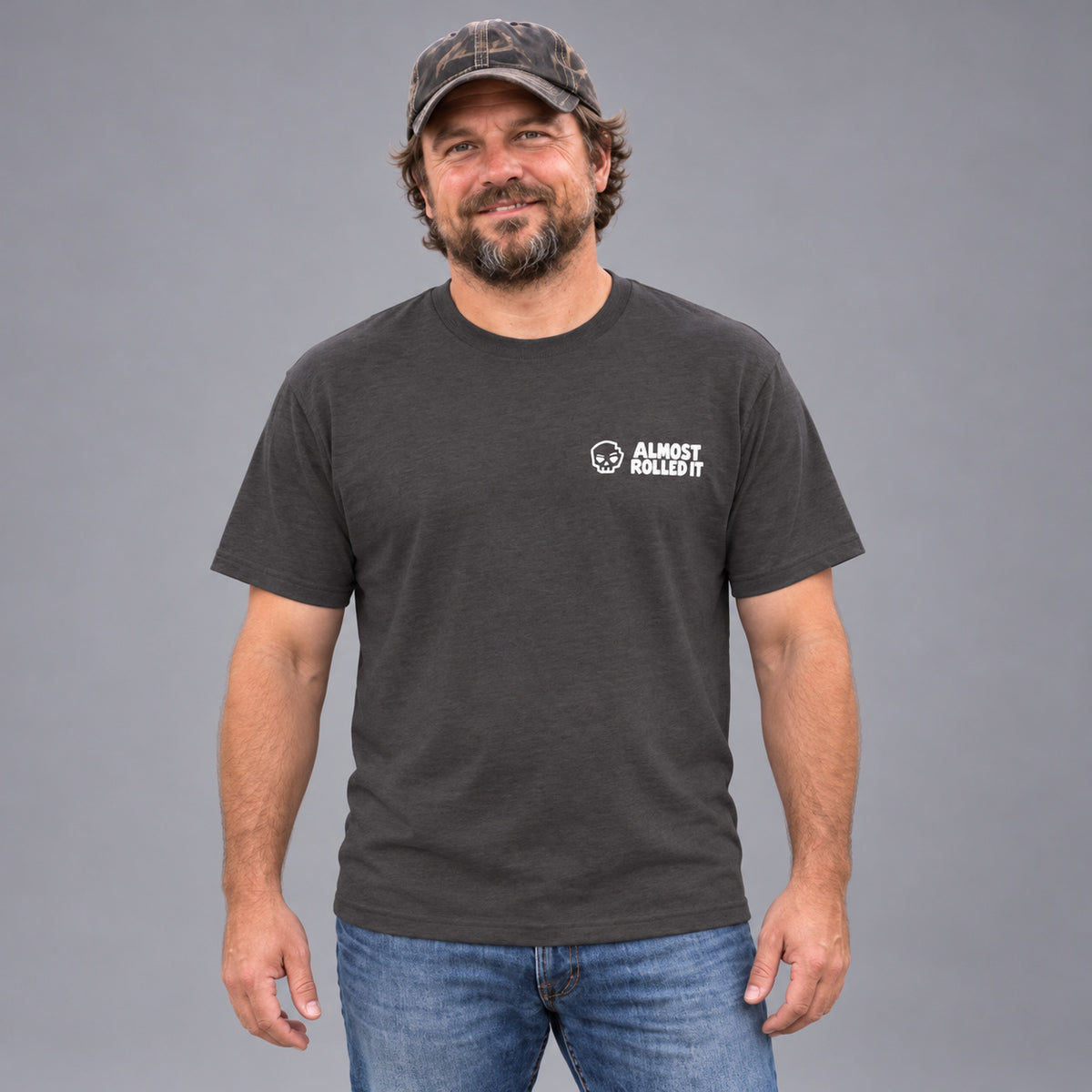 I like 'em wide Tee in Charcoal — male model in a front studio view showing the wearer-left ARI chest print.