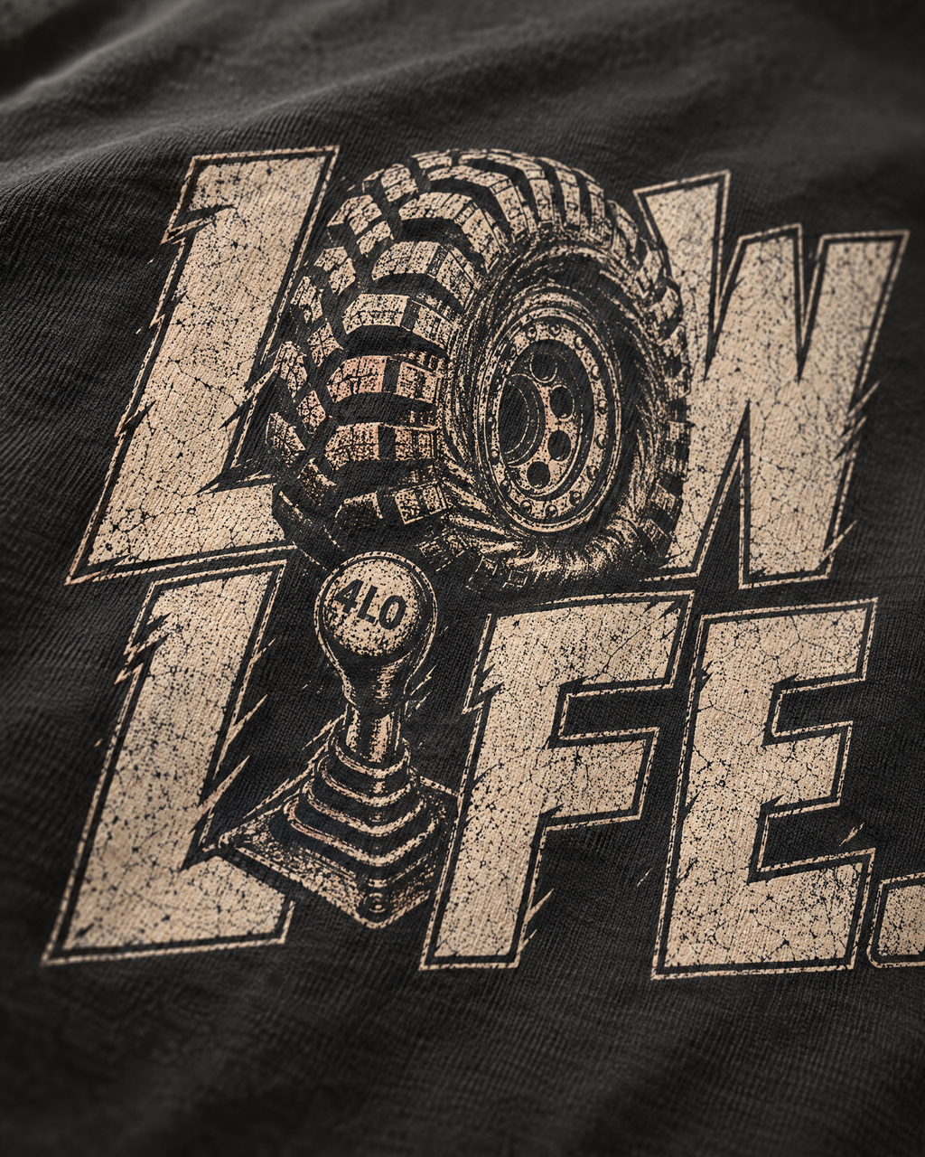 Close-up of the Low Life print: distressed cream ink on soft ring-spun cotton