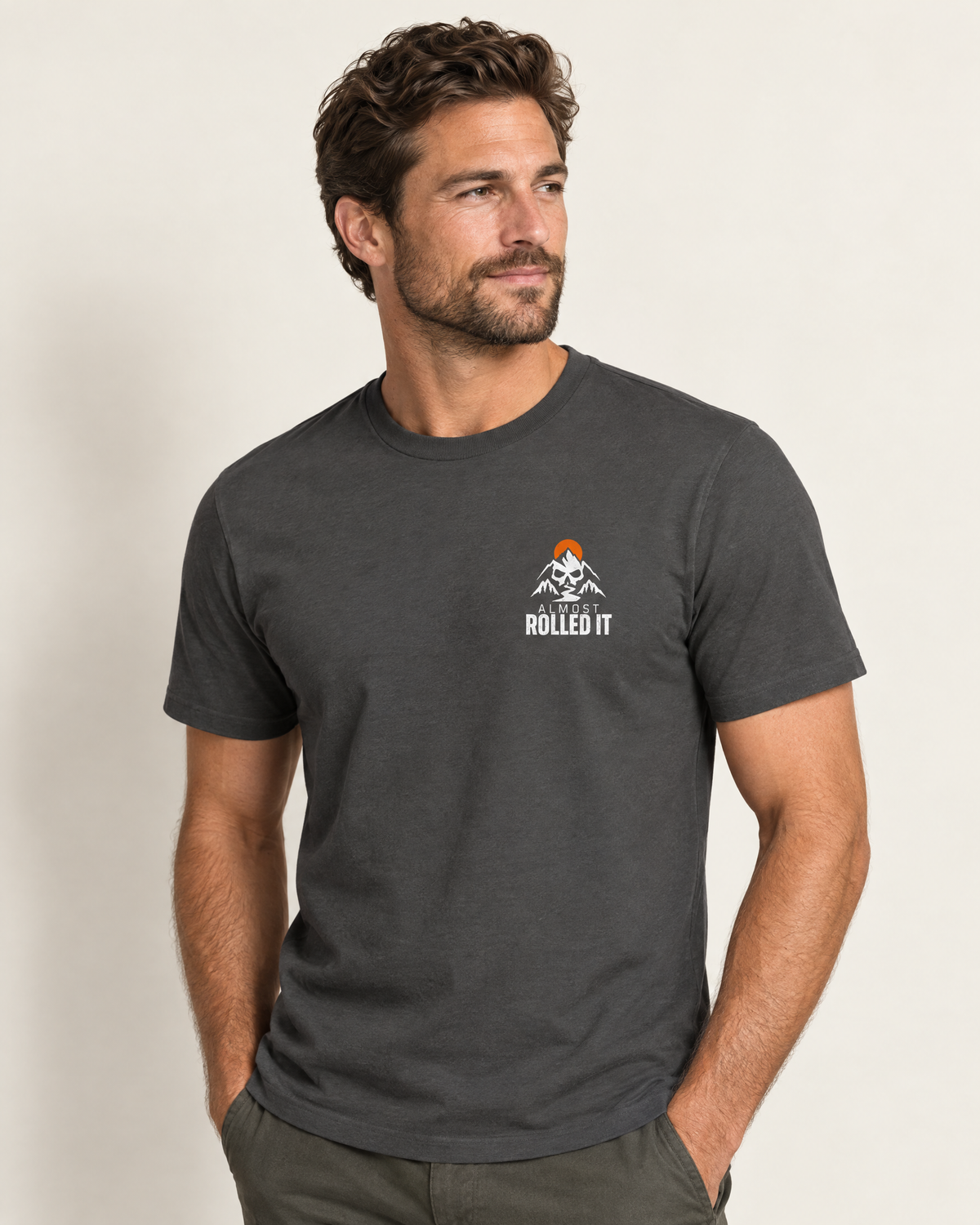 Front of the Low Life tee on a model: small skull-and-mountains Almost Rolled It chest logo