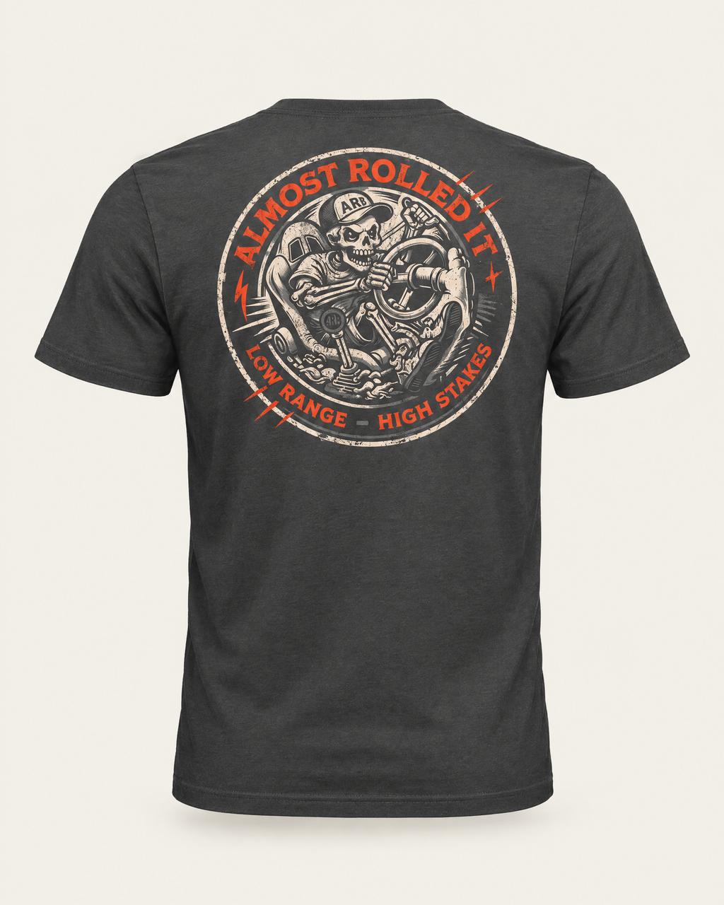 4Lo Skull tee in dark grey, back view: round distressed badge with a skeleton driver, Almost Rolled It and Low Range, High Stakes
