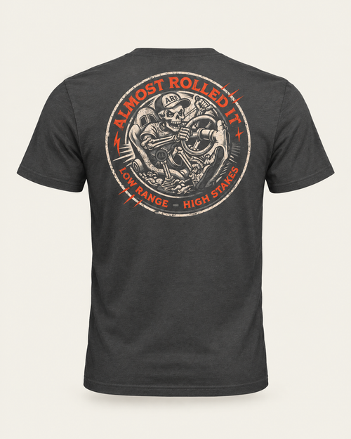 4Lo Skull tee in dark grey, back view: round distressed badge with a skeleton driver, Almost Rolled It and Low Range, High Stakes