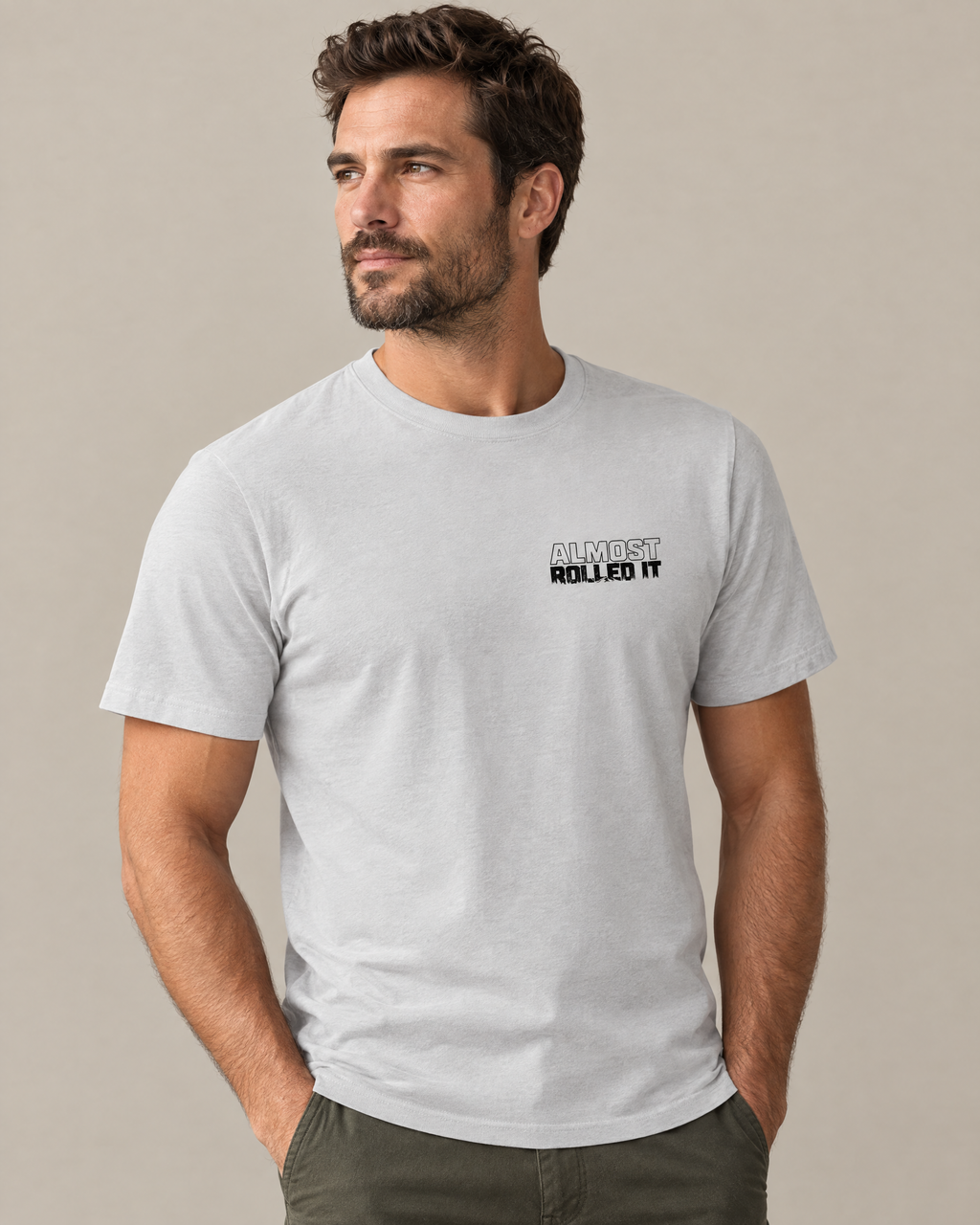 Front of the silver Tons & 42s tee on a model: small black Almost Rolled It wordmark