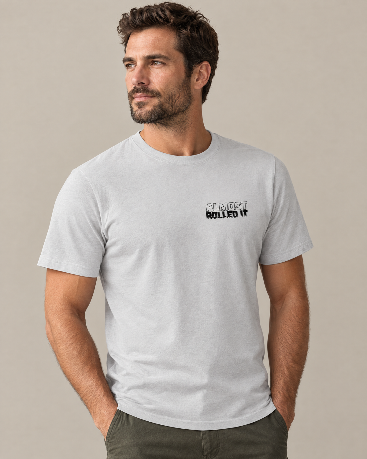 Front of the silver Tons & 42s tee on a model: small black Almost Rolled It wordmark
