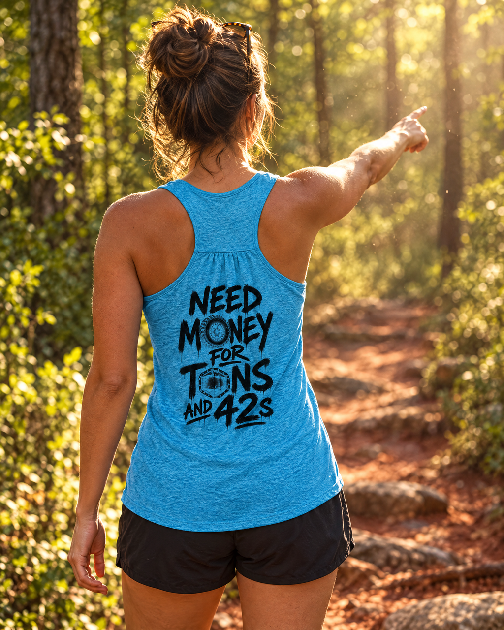 Woman spotting on a red-clay trail in the Tons & 42s tank