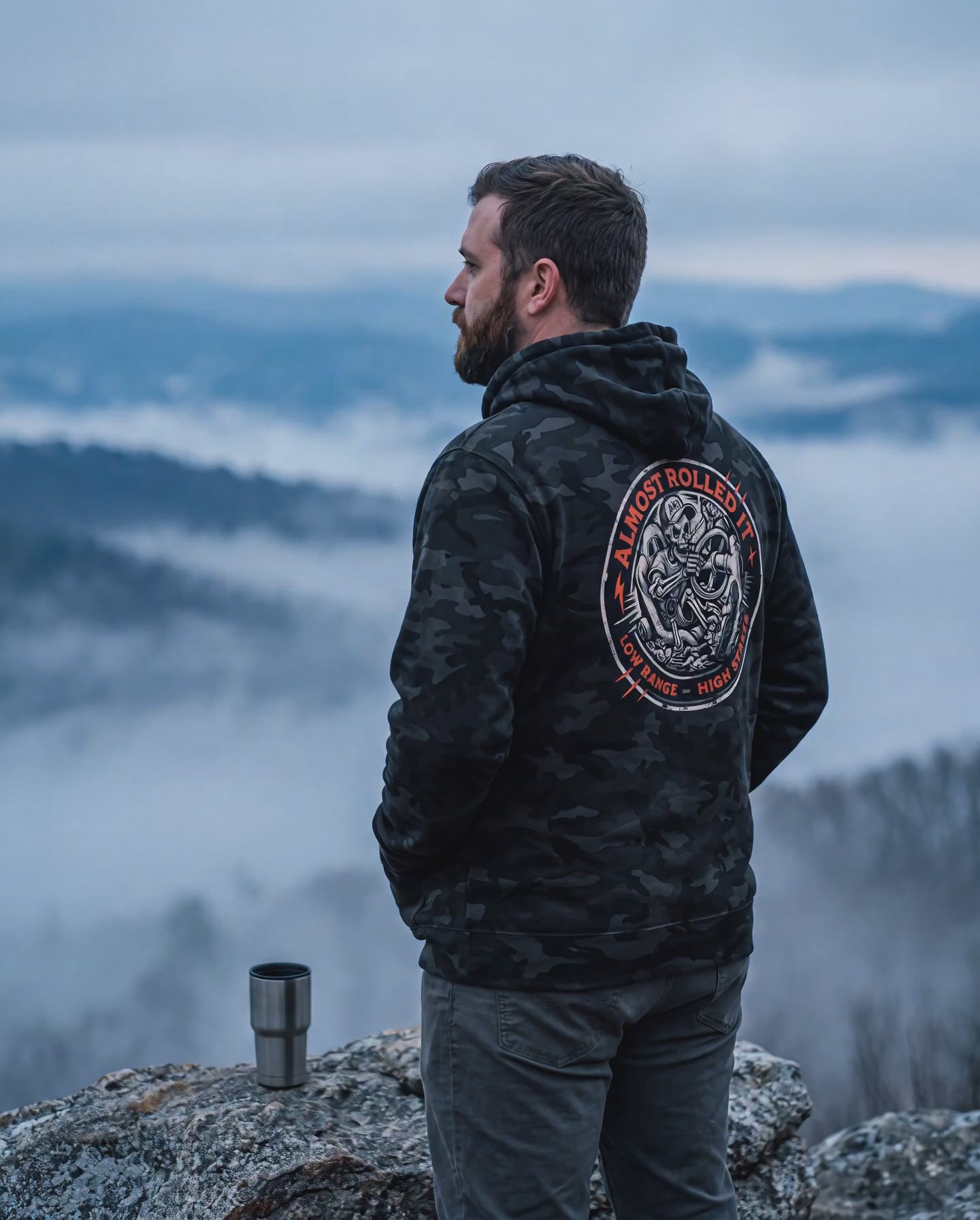 Fog drifting below a man in the 4Lo Skull camo hoodie