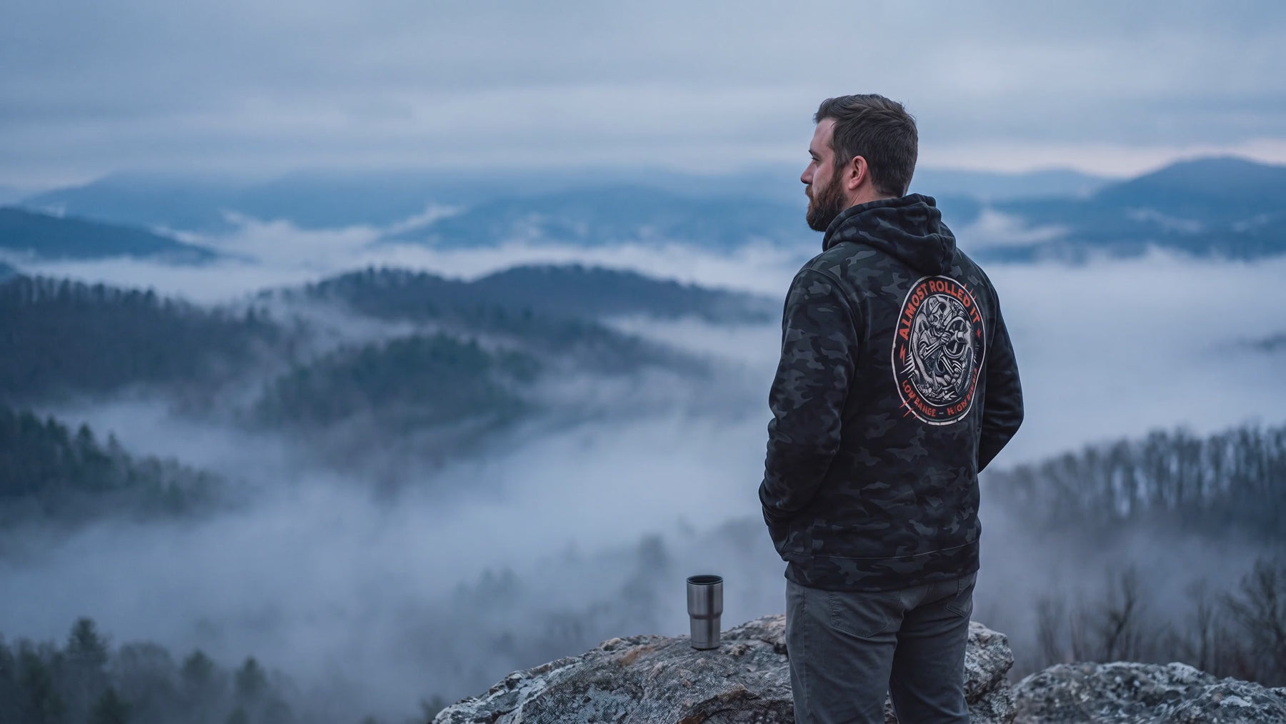 Fog drifting below a man in the 4Lo Skull camo hoodie