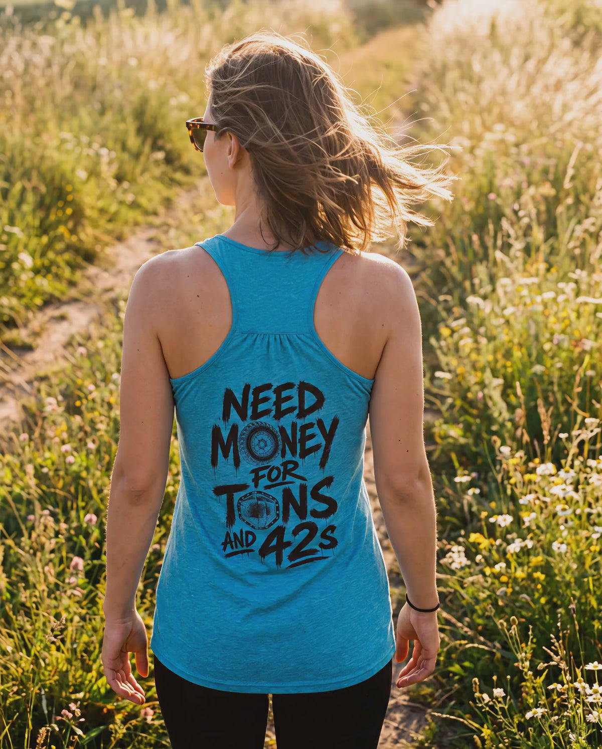 Woman in the turquoise Tons and 42s tank walking a summer trail