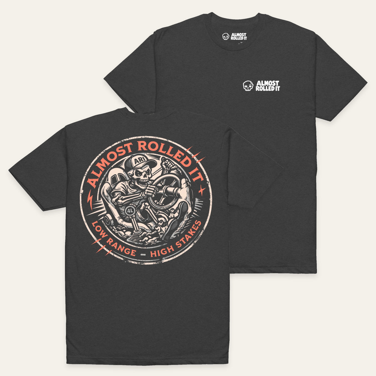 Skull Driver Tee in Charcoal — paired flat lay, back lower left and front upper right. Supplier-derived product mockup.